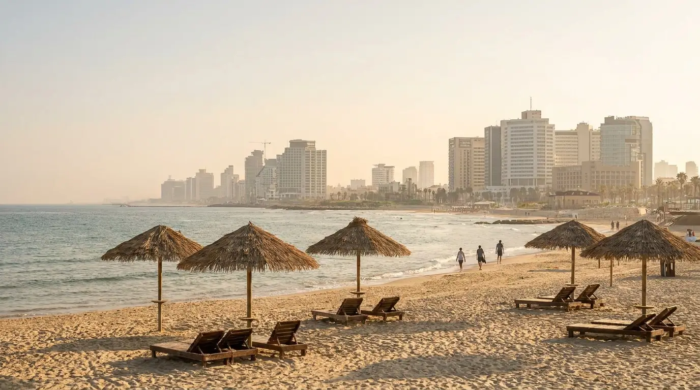 Straw parasols on the beach with the city skyline along the shore